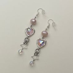 "Handmade Beaded Earrings ✿ Made with glass beads, freshwater pearls, glass crystal beads, and metal accents ✿ Silver, iridescent pink, iridescent clear, and pearlescent peach ✿ The earrings are 2.25\" long (2.75\" total)" Pink Metal Dangle Beaded Earrings, Pink Metal Crystal Earrings, Pink Beaded Metal Earrings, Pink Pearl Earrings For Party, Pink Metal Drop Earrings, Pink Pearl Jewelry With Dangling Beads, Pink Metal Beaded Drop Earrings, Pink Dangle Crystal Earrings, Pink Dangle Earrings With Pearl Charm