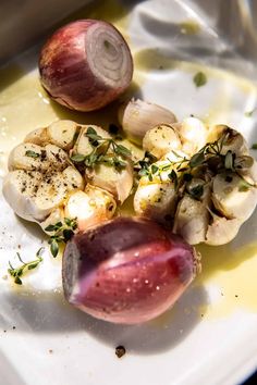 an onion and garlic dish on a white plate