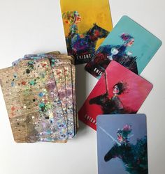 four coasters with different designs on them