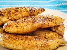 three pieces of chicken sitting on top of a white plate