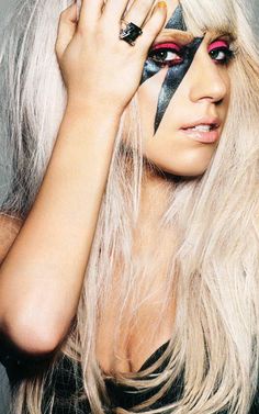 a woman with long white hair and makeup