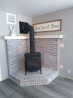 a brick fireplace with a sign above it that says home sweet home on the wall