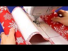 someone is using a sewing machine to sew christmas wrappings on a table top