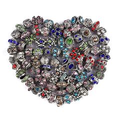 a heart shaped brooch with many different colored beads