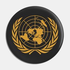 the united nations emblem on a black and gold button with an orange circle around it