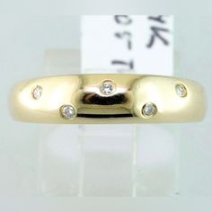 a gold ring with three diamonds on it