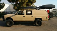 an suv with a kayak on the roof