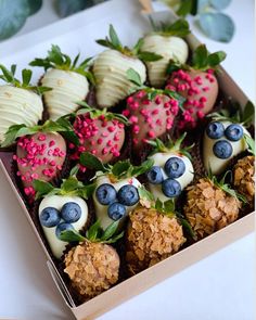 a box filled with chocolate covered strawberries and blueberries on top of each other