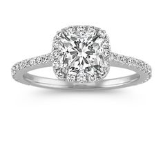 a cushion cut diamond engagement ring with pave set shoulders