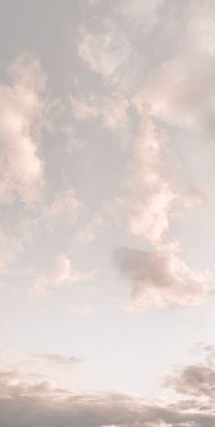 two people standing on the beach flying a kite