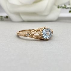 This beautiful ring is made from genuine 925 sterling silver with rose gold plating. Ring details- -The Main stone is a round cut 6mm Natural Aquamarine Stone -Side stones are round 1.6mm and 1mm simulated diamonds -Ring is casted in solid 925 sterling silver with rose gold plating (yellow gold and rhodium plated also available, please check the drop down menu for more options) -The Total face height of the ring measures 7.5mms and the band width measures 2mms -Each ring is handmade, so please a Formal Rose Gold Round Birthstone Ring, Anniversary Filigree Birthstone Ring, 14k Rose Gold Sapphire Ring, 14k Gold Filigree Round Ring For Promise, Rose Gold Topaz Ring With Prong Setting, Rose Gold Topaz Promise Ring, Elegant Round Filigree Ring With Birthstone, Rose Gold Birthstone Ring With Diamond Cut, Round Filigree Promise Ring With Birthstone