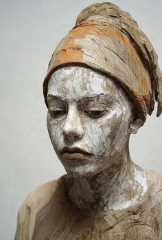 a close up of a statue of a person with white paint on it's face