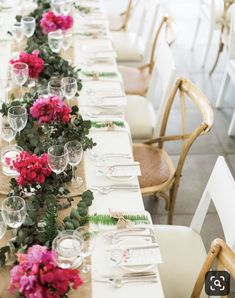 a long table is set with flowers and place settings