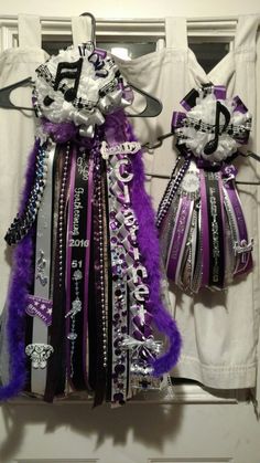 two purple and black ribbons hanging from hooks