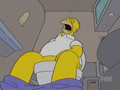 the simpsons is sitting in an airplane with his mouth open