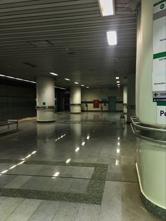 an empty parking garage with benches and lights