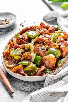 a bowl filled with meat and vegetables on top of a table