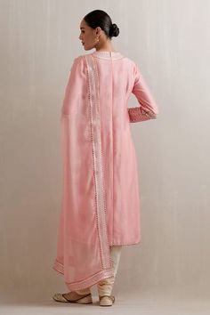 Chalk pink kurta with aari, sequin, zari embroidered neckline and sleeve hem. Paired with cotton cream churidar and dupatta. - Aza Fashions Pink Raw Silk Unstitched Suit With Traditional Drape, Pink Unstitched Suit With Dupatta In Raw Silk, Pink Raw Silk Unstitched Suit With Resham Embroidery, Pink Anarkali Unstitched Tissue Silk Suit, Pink Raw Silk Unstitched Suit With Dupatta, Pink Traditional Wear With Gota Work In Raw Silk, Pink Unstitched Suit With Gota Work In Traditional Drape, Pink Raw Silk Traditional Wear With Mirror Work, Pink Tissue Silk Dupatta With Gota Work