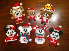 a group of beaded mickey mouses on a wooden table next to each other