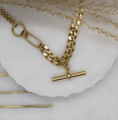 "Curb Gold This is a beautiful super trendy necklace for layering and for everyday wear. * DETAILS * ✤ Available in 14k Gold plated over brass ✤ Model is wearing size 16\" ✤ Toggle bar hang as a charm ✤ Available in Size 16\" 18\" and 20\" * PACKAGING * - Purchase is packaged in a Tommassini Jewelry box. - If you purchase more than one item, I will place it all into one box, unless requested otherwise in a note. * DON'T FORGET US * Instagram: https://instagram.com/tommassini_jewelry Facebook: ht Chic Gold Chain Toggle Necklace As Gift, Chic Gold Chain Toggle Necklace Gift, Chic Gold Toggle Necklace For Gift, Trendy Tarnish-resistant Chain Link Necklace, Minimalist Chunky Chain Toggle Necklace Gift, Gold Toggle Necklace With Chain Link, Gold Toggle Necklace With Chunky Chain, Modern Chunky Chain Necklace Gift, Trendy Gold Chain Link Charm Necklace