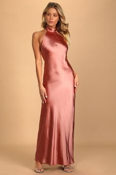 a woman in a pink dress posing for the camera