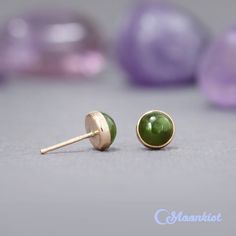 These Natural Jade Stud Earrings feature lovely 6 mm green jade cabochons. These matched green stones are carefully set in gold filled bezels here in our studio. These bezels are firmly soldered to posts and tumble polished for hours to a high shine. Jade has been used from prehistoric periods for hardstone carving. Material - gold filled post, gold filled bezel, 6 mm green jade cabochons, gold filled earring backs Dimensions - Cabochons measure 6 mm in diameter, Stud posts are 11 mm long in a 2 Green 14k Gold Earrings With Bezel Setting, Green Earrings With Bezel Setting For May Birthstone, Prehistoric Period, Small Stud Earrings, Green Stones, Jade Earrings, Nephrite Jade, Small Earrings Studs, Gold Filled Earrings