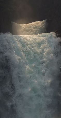 the sun shines through the water as it pours into a river with rapids