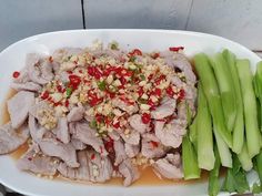 a white plate topped with meat and veggies