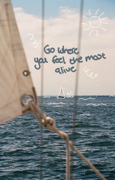 a sailboat in the ocean with a quote written on it's front side