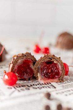 two pieces of chocolate cake with cherries on top