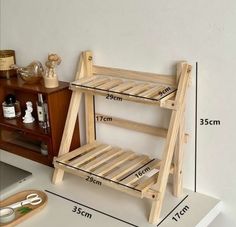 a wooden shelf with two shelves on each side and measurements for the bottom half of it