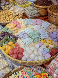 many different types of candies in baskets on display