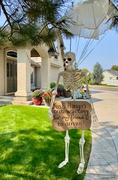 a skeleton holding a sign that says, just hangin'with my friend leave