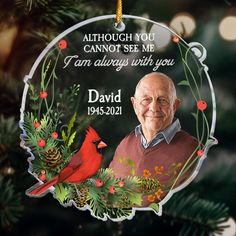 a christmas ornament with an image of a man and a cardinal on it