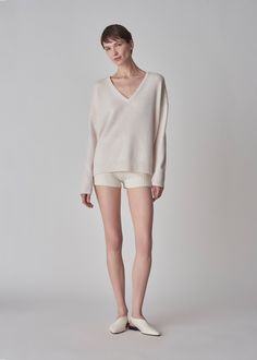 A relaxed v-neck sweater in boiled cashmere with rib trim. Details Ivory boiled cashmere sweater Deep v-neckline Relaxed fit Rib trim at neck, cuffs, and hem 100% Cashmere 7291CMR-ESSN Designed for a relaxed fit. Size down for a slimmer fit. Model is 5'11" and wears a size Small. Cream Cashmere Sweater, Exclusive Dress, Silk Knit, Silk Yarn, Ribbed Texture, Silk Wool, Cotton Viscose, Cashmere Sweater, V Neck Sweater