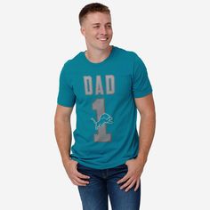 He’s not just your dad, he’s the best one around! A dad as amazing as yours deserves a shirt that shows off his favorite team. Make sure everyone knows how great of a dad and fan he is with this Detroit Lions #1 Dad T-Shirt. This top features a design that showcases your all-important team colors and a bold team logo display across the chest, meaning this t-shirt will prove your unmatched dedication to the Detroit Lions when you’re at the game or watching at home with your #1 family. In other wo Game Day T-shirt With Team Name For Father's Day, Team Name T-shirt For Game Day On Father's Day, Game Day Team Spirit T-shirt For Father's Day, Team Name T-shirt For Game Day, Father's Day Team Spirit T-shirt With Crew Neck, Father's Day Team Spirit Crew Neck T-shirt, Father's Day Game Day T-shirt With Team Spirit, Father's Day Fan Apparel T-shirt With Team Name, Father's Day Team Spirit Tops With Team Name