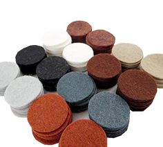 several different types of felt discs on a white background