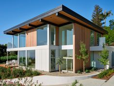 a modern house with lots of windows on the outside