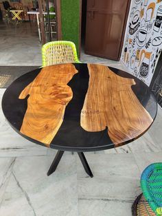 a table made out of wood and metal with two dogs painted on the top, sitting in front of a store