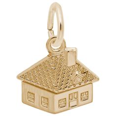 a gold charm with a small house on it