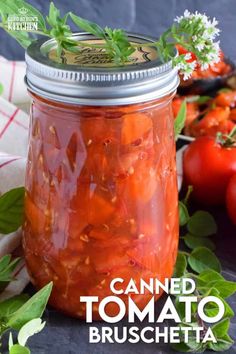 a jar filled with canned tomato sauce next to fresh tomatoes and basil on a table