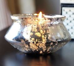 a lit candle sitting on top of a table