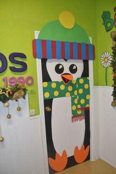 a decorated door with a penguin wearing a hat and scarf on it's head