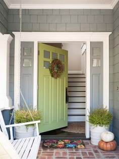 a green door is open on the front porch