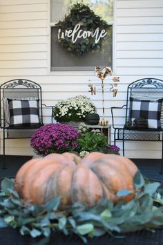 some pumpkins are sitting on the front porch