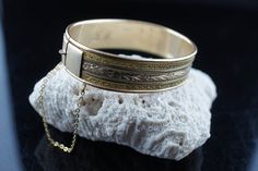 This is the perfect option for those who like cool, unique jewelry and the luxury, shine of gold. This bracelet is well made, cute and/or elegant in design, and very desirable. The bracelet is opened. The bracelet is decorated with floral pattern. It has a secure chain. The clasp is in perfect working condition. ♥ Age/era: Circa 1970s - 1980s. ♥ There is no hallmark. There is monogram L.D. ♥The bracelet is gold filled. ♥ The bracelet is about 2 1/4 inches by 1 3/4 inches. ♥The bracelet is for sm Antique Gold Rectangular Bracelet, Gold Rectangular Cuff Bracelet Gift, Elegant Rectangular Engraved Bracelets, Elegant Engraved Rectangular Bracelets, Elegant Rectangular Engraved Gold Bracelet, Vintage Bangle Chain Bracelet As Gift, Gold Rectangular Bangle Gift, Flower Monogram, Design Flower