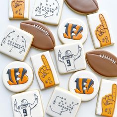 decorated cookies with footballs and symbols on them