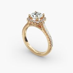 a yellow gold engagement ring with an oval diamond center and side stones on the band