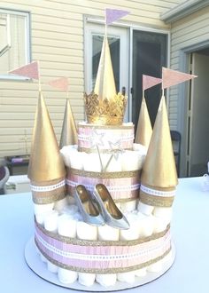 there is a cake decorated with gold and pink decorations on it's stand,