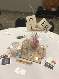 a table topped with lots of cards and vases filled with flowers on top of it